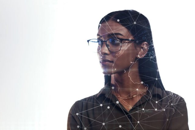 A South East Asian woman wearing glasses overlayed with holographic nodes over her face.