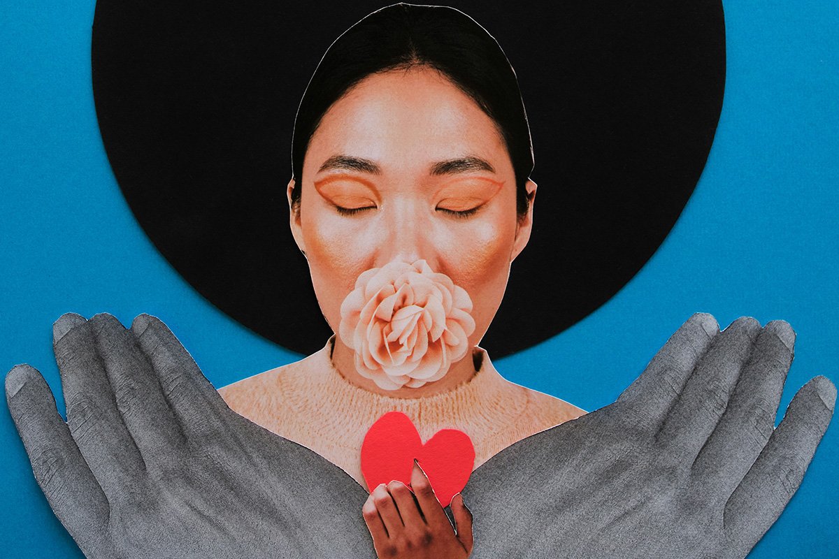 A paper collage of a woman whose eyes are closed with a flower emerging from her mouth. Below her, two hands prop her up while a central hands hold up a heart.