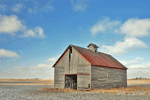 dilapidated farm and big sky